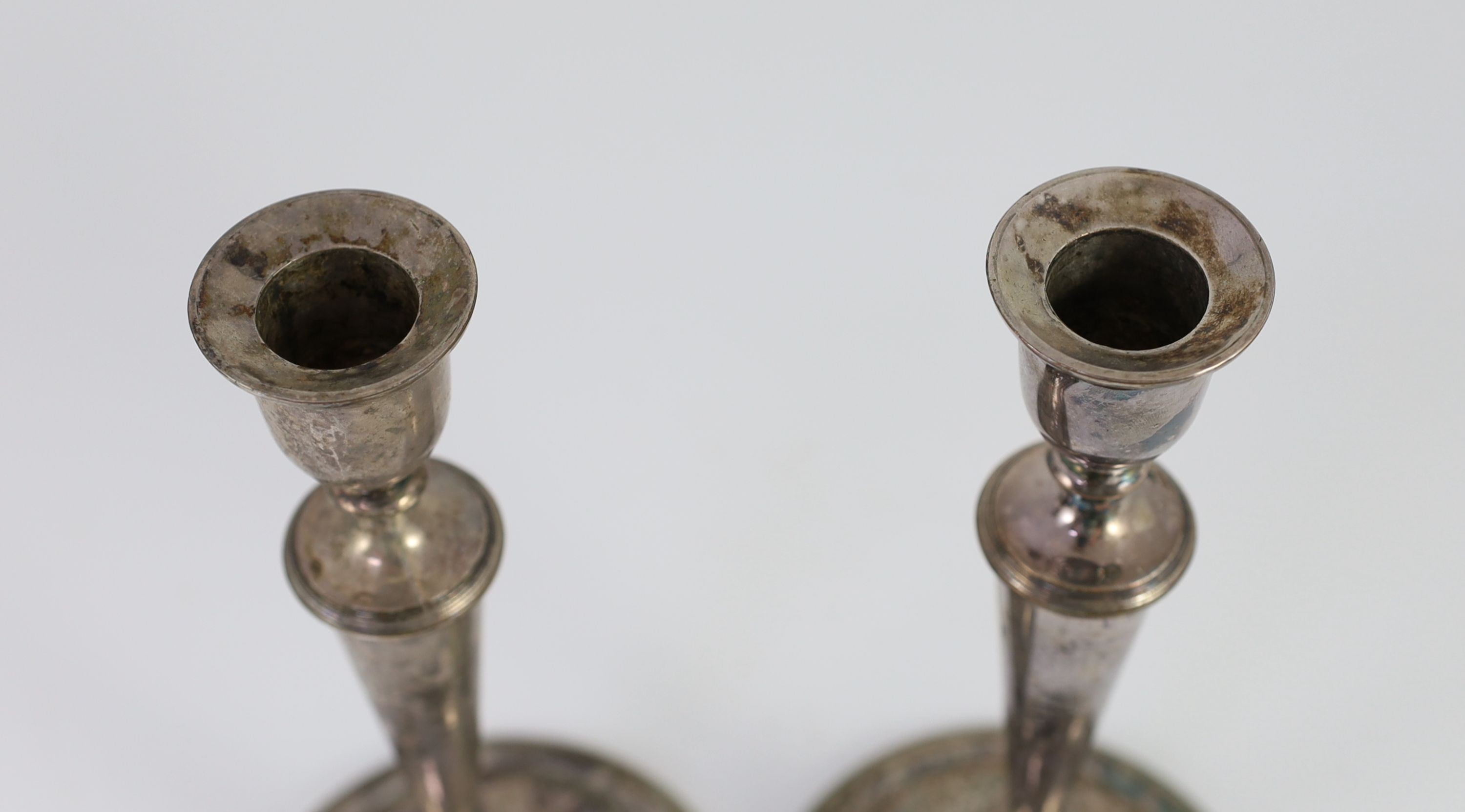 A pair of Sheffield plate candlesticks and nozzles, 26cm high